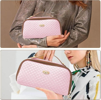 Pink quilted handbag held by a person against a neutral background
