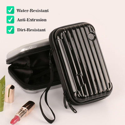 Black travel case with makeup items on a light background